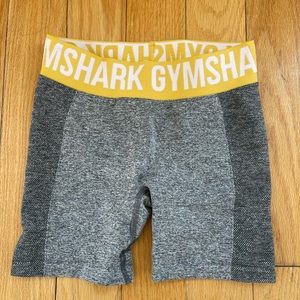 Gymshark grey countoured biker shorts. Yellow waistband.